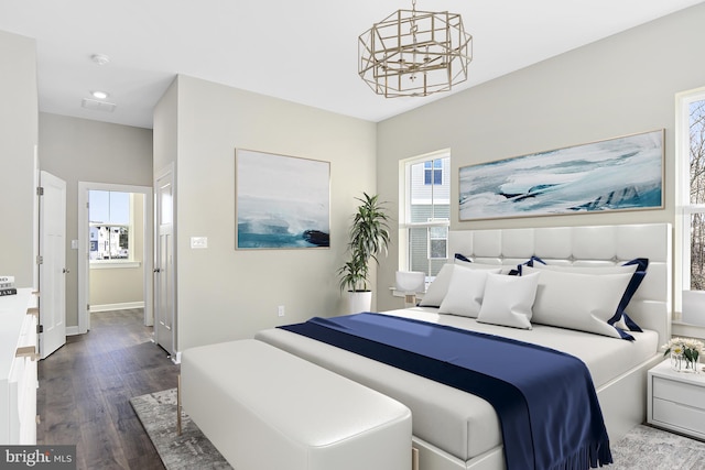 bedroom featuring hardwood / wood-style floors and a notable chandelier