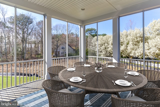 sunroom / solarium with outdoor dining area