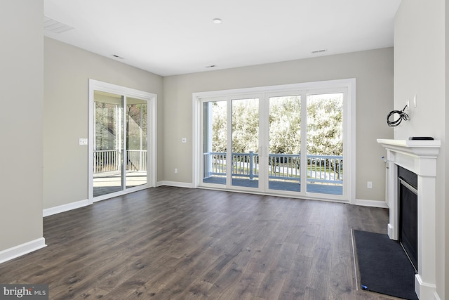 unfurnished living room featuring dark hardwood / wood-style flooring