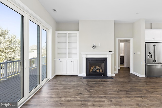 unfurnished living room featuring dark hardwood / wood-style floors