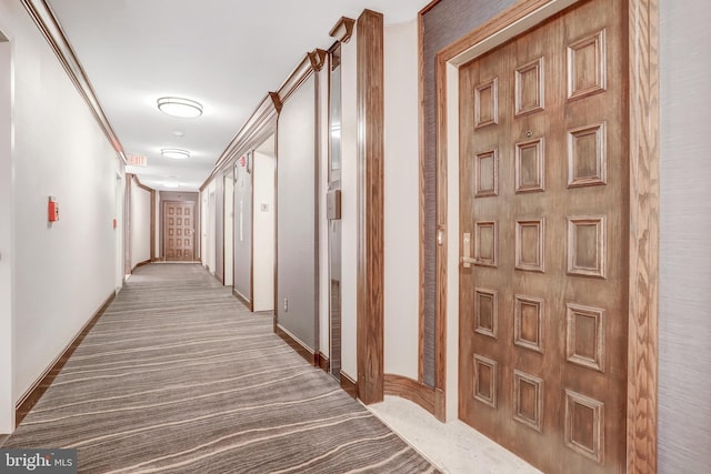 hall with carpet and baseboards
