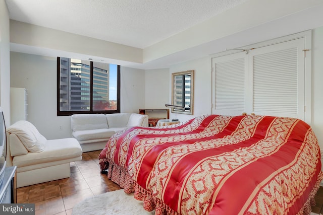 bedroom with a closet and a textured ceiling
