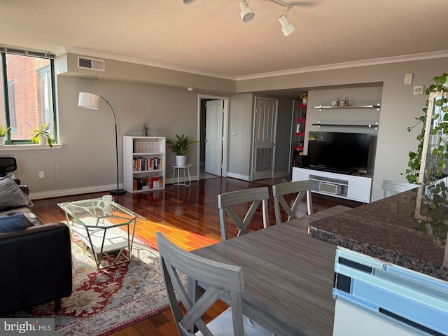 living room featuring hardwood / wood-style flooring, track lighting, and ornamental molding