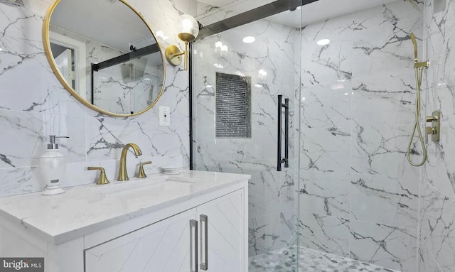 bathroom featuring vanity, a shower with door, tile walls, and backsplash