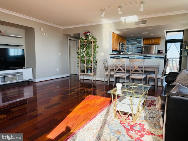 living room with ornamental molding, track lighting, and dark hardwood / wood-style flooring