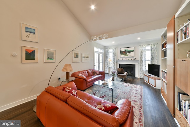 living room featuring dark hardwood / wood-style floors, a healthy amount of sunlight, and vaulted ceiling