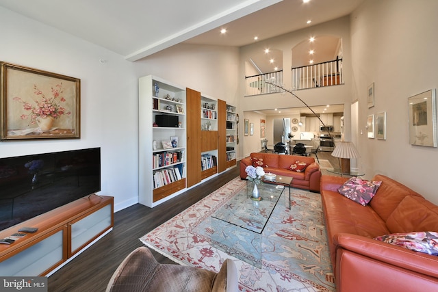 living room featuring dark hardwood / wood-style floors and high vaulted ceiling