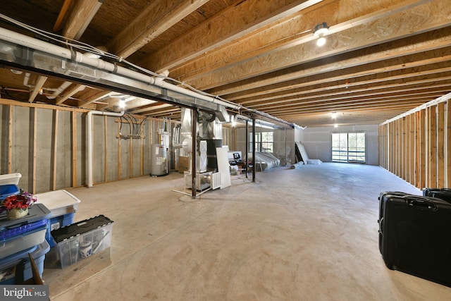 basement featuring heating unit and water heater