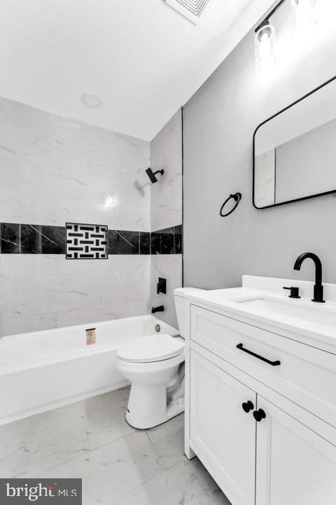 full bathroom featuring toilet, vanity, and tiled shower / bath combo