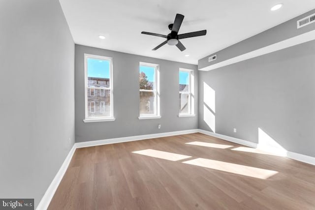 unfurnished room with light wood-type flooring and ceiling fan