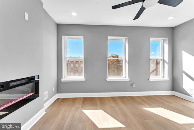 unfurnished living room featuring light hardwood / wood-style floors and ceiling fan