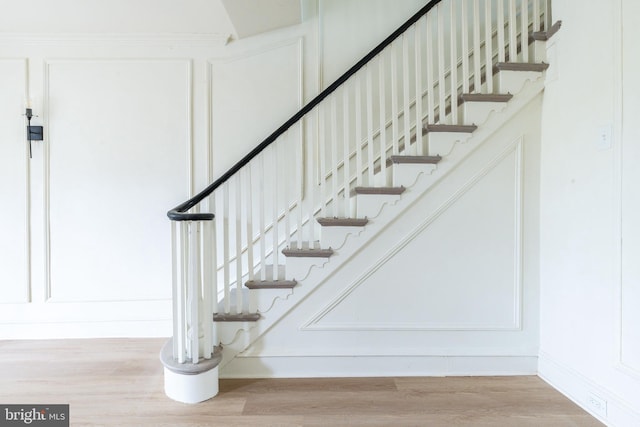 stairs featuring hardwood / wood-style floors