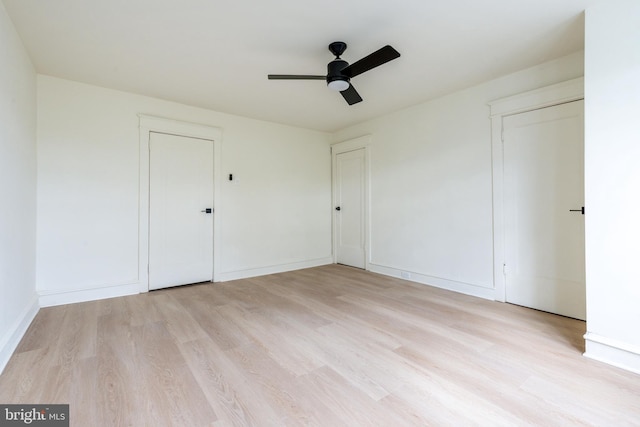 empty room featuring ceiling fan and light wood-type flooring