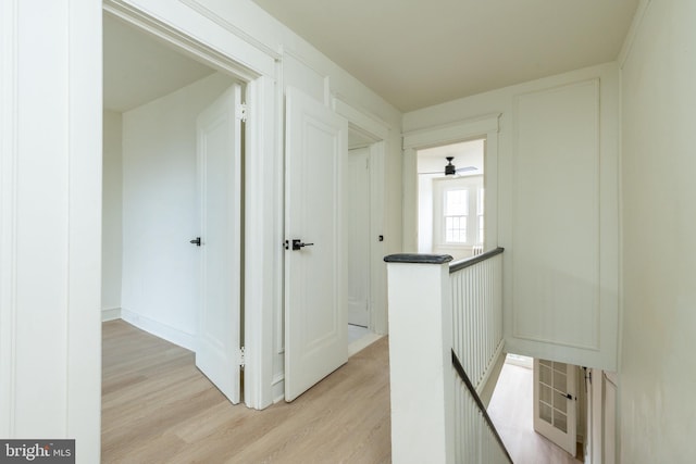 hallway with light hardwood / wood-style floors