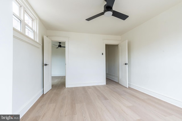 unfurnished bedroom with ceiling fan and light hardwood / wood-style flooring