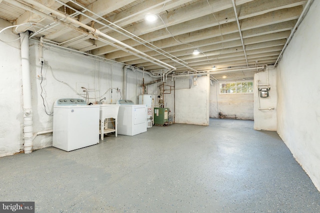 basement featuring water heater and washer and clothes dryer