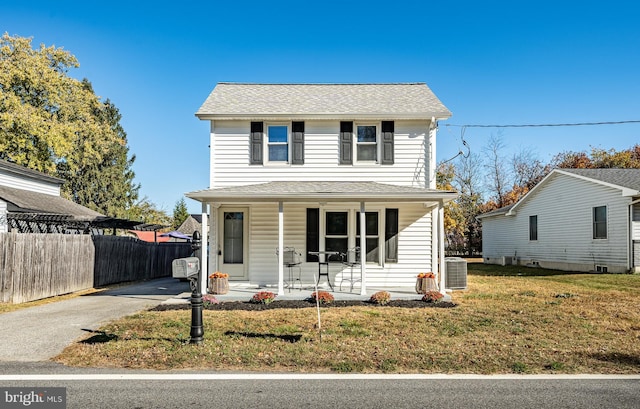 325 Howell School Rd, Bear, DE 19701 - traditional-style house featuring covered porch, aphalt driveway, fence, central AC, and a front yard