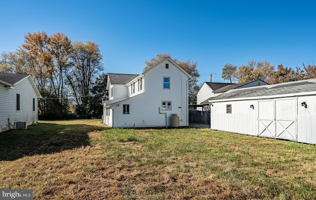 325 Howell School Rd, Bear, DE 19701 - rear view of house featuring a yard, cooling unit, an outbuilding, and a storage shed