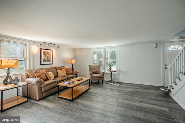 325 Howell School Rd, Bear, DE 19701 - living area featuring wood finished floors, track lighting, a wealth of natural light, a decorative wall, and stairs