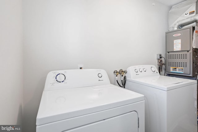 clothes washing area with separate washer and dryer