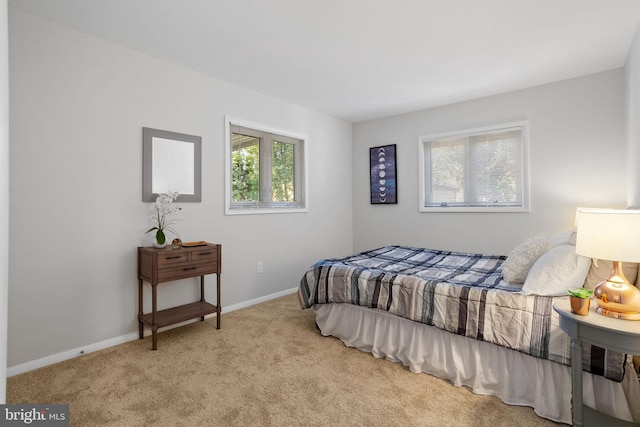 carpeted bedroom featuring multiple windows