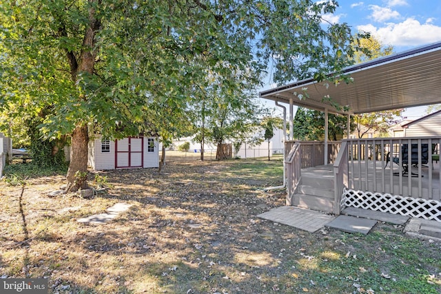 view of yard with a storage shed and a wooden deck