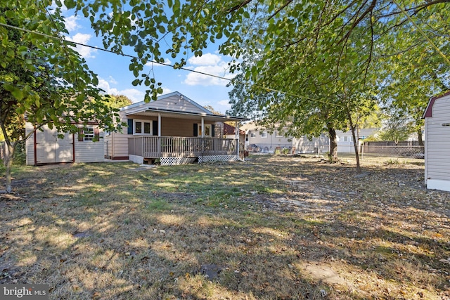 view of yard featuring a wooden deck and a shed