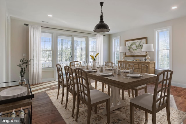 dining space with recessed lighting, baseboards, and wood finished floors