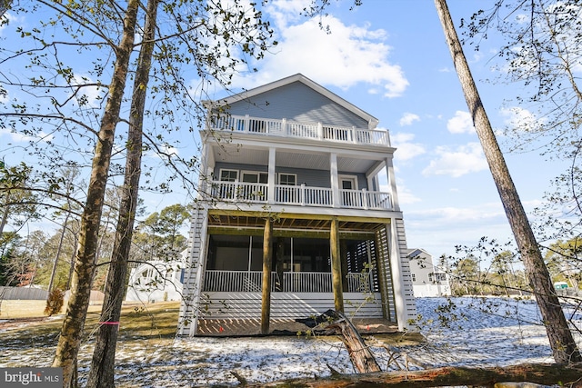 view of front of home with a balcony and a sunroom