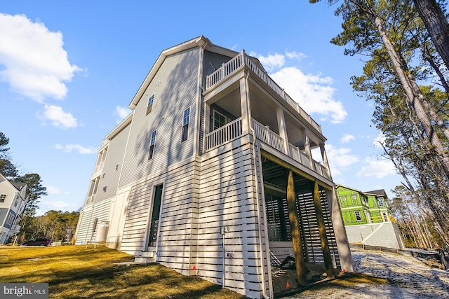 view of side of home with a balcony