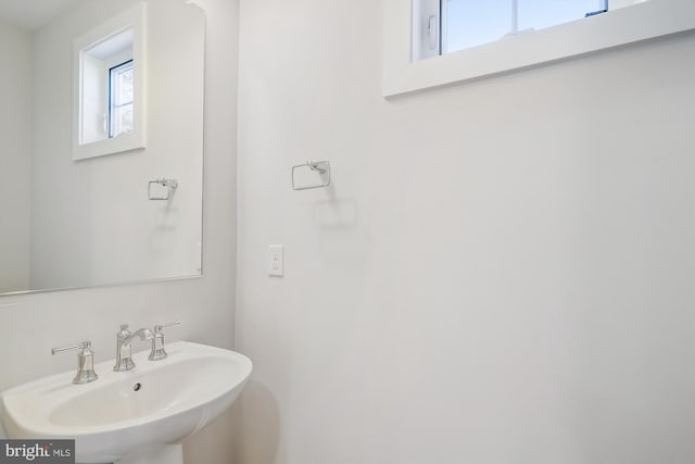 bathroom featuring a wealth of natural light and a sink