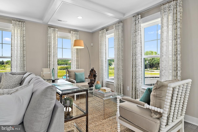 sitting room with beamed ceiling and wood-type flooring