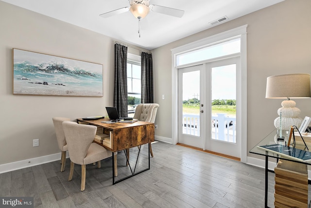 dining area featuring wood-type flooring, french doors, and ceiling fan