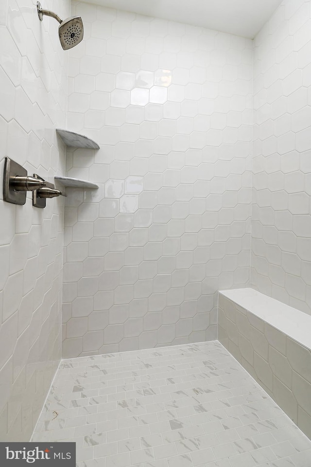 bathroom with tiled shower