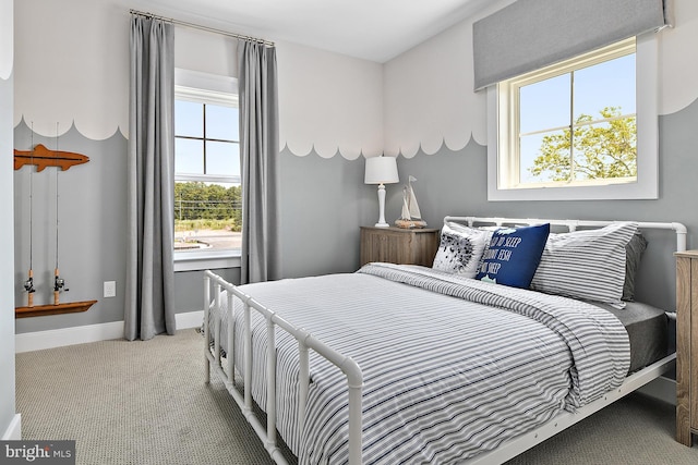 carpeted bedroom featuring multiple windows