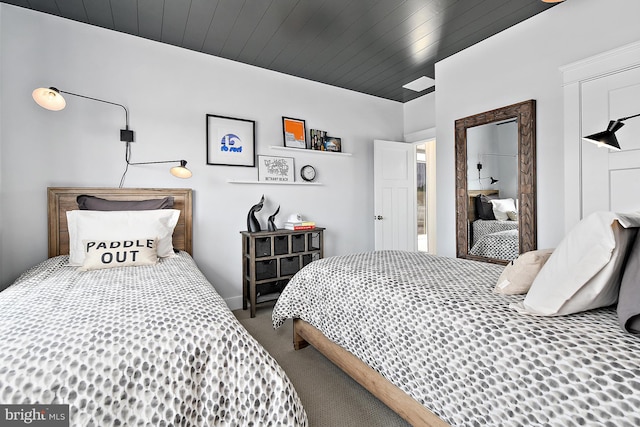 carpeted bedroom featuring wooden ceiling