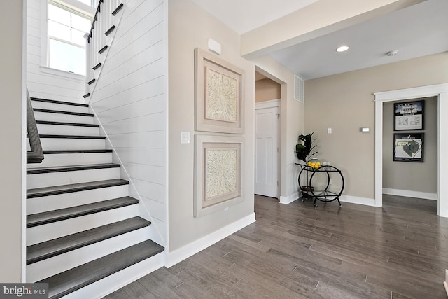 staircase with hardwood / wood-style flooring