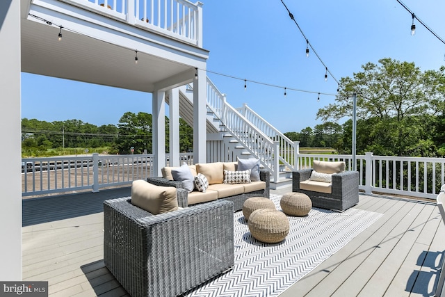 wooden terrace with an outdoor hangout area