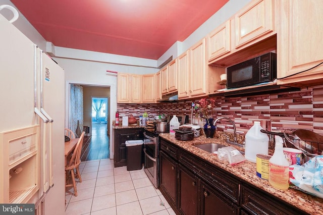 kitchen featuring backsplash, sink, light stone countertops, stainless steel range with electric stovetop, and light tile patterned floors