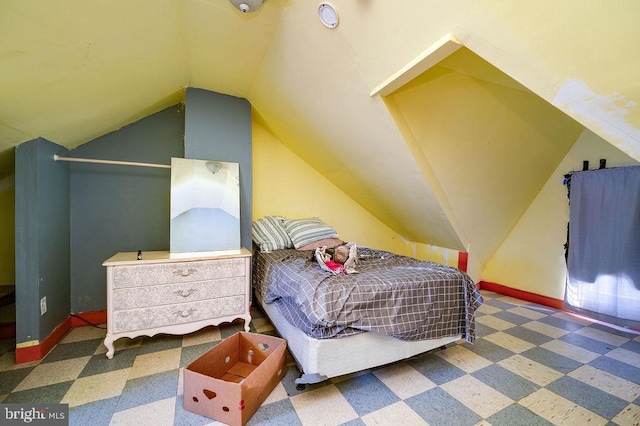 carpeted bedroom featuring lofted ceiling