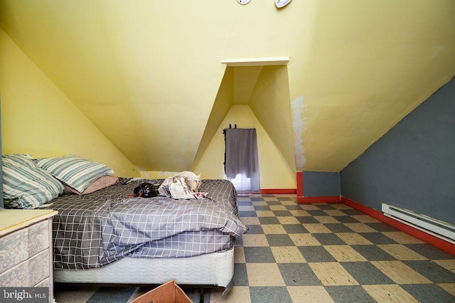 bedroom featuring baseboard heating and vaulted ceiling