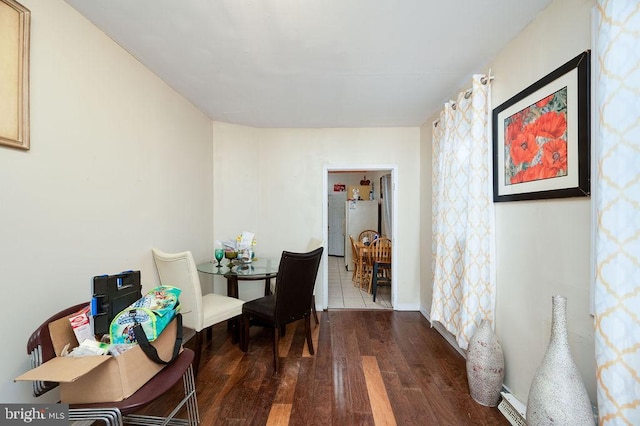 dining area with dark hardwood / wood-style floors