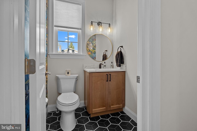 bathroom with vanity, toilet, and tile patterned flooring