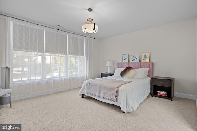 bedroom with multiple windows and carpet floors