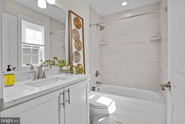 full bathroom with vanity, toilet, and tiled shower / bath combo