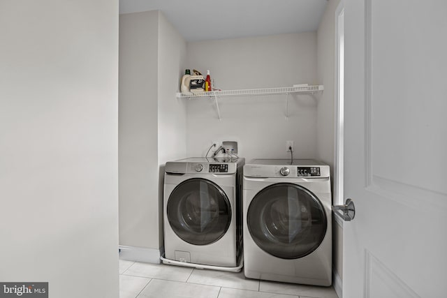 washroom with separate washer and dryer and light tile patterned floors