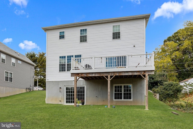 rear view of house with a deck and a yard