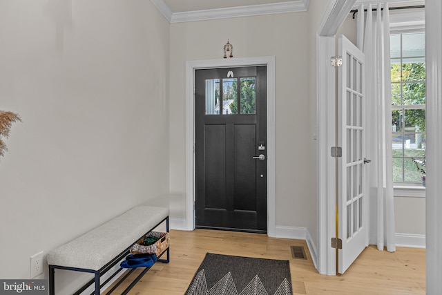 entryway featuring crown molding and light hardwood / wood-style flooring