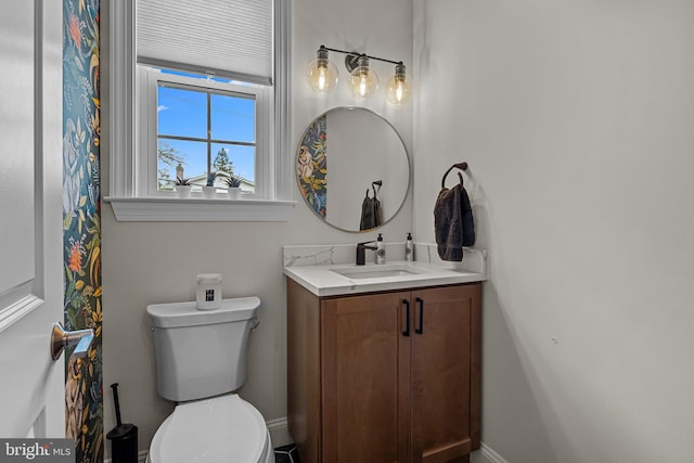 bathroom featuring vanity and toilet