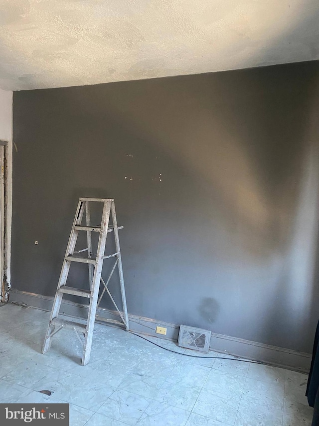 empty room featuring a textured ceiling